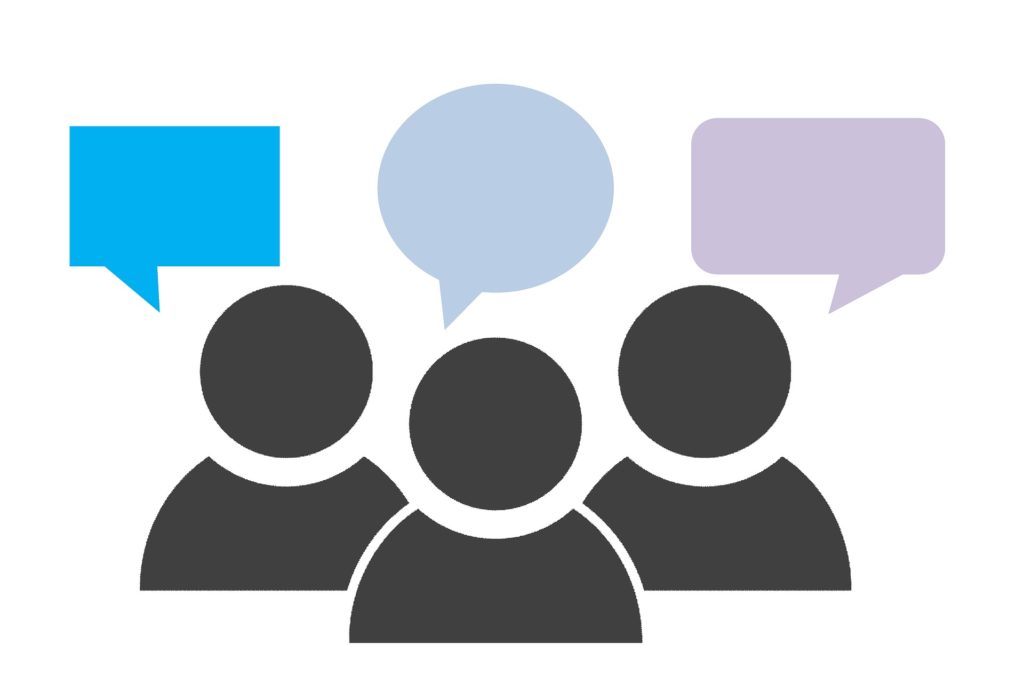 icon illustration of three people, each with a different colored speech bubble. There is no text in the speech bubbles.