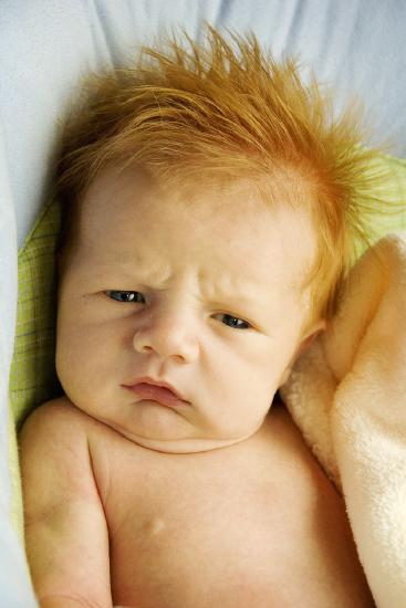 An infant boy with reddish orange hair.