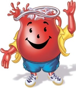 A giant pitcher of kool-aid wearing shorts and a yellow button up, smiling.