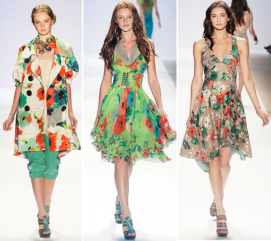 Three models walking down a runway wearing stylish floral dresses.