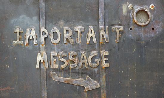 A sign on a metal door reads "Important Message" with an arrow pointing to the right.